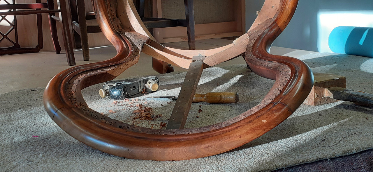 Repairing the back of an antique chair; setting in new mahogany